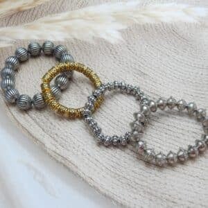 Dual tone oxidised bracelet set of four — three silver finish and one antique gold bead stretch bracelet
