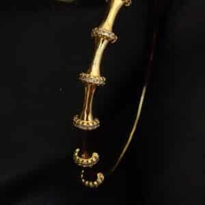 side view of Bamboo anti tarnish kada for women in gold-toned segmented design with American diamond stones