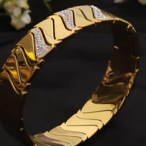 Wave anti tarnish kada for women in gold-toned diagonal wave design with American diamond stones