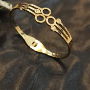 Anti tarnish cuff bracelet for women in gold-toned circle design with American diamond stones