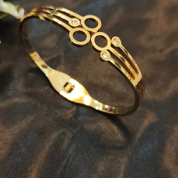 Anti tarnish cuff bracelet for women in gold-toned circle design with American diamond stones