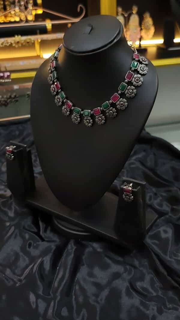 Oxidised floral necklace set in Ruby Emerald with matching earrings