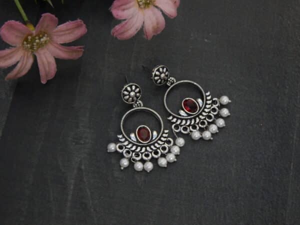 Oxidised silver chandbali earrings in red with pearl fringe