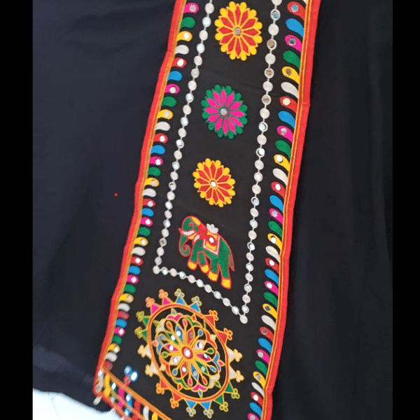Black embroidered lehenga belt with long hanging panel worn at the waist for garba
