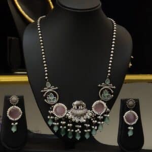 Oxidised elephant pendant necklace set with pearl and sea green stone tassels