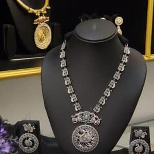 Oxidised brass peacock medallion necklace set with earrings in sea green stone