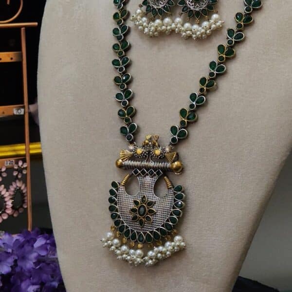 Side view of Victorian peacock necklace set showing floral link chain and pendant detail